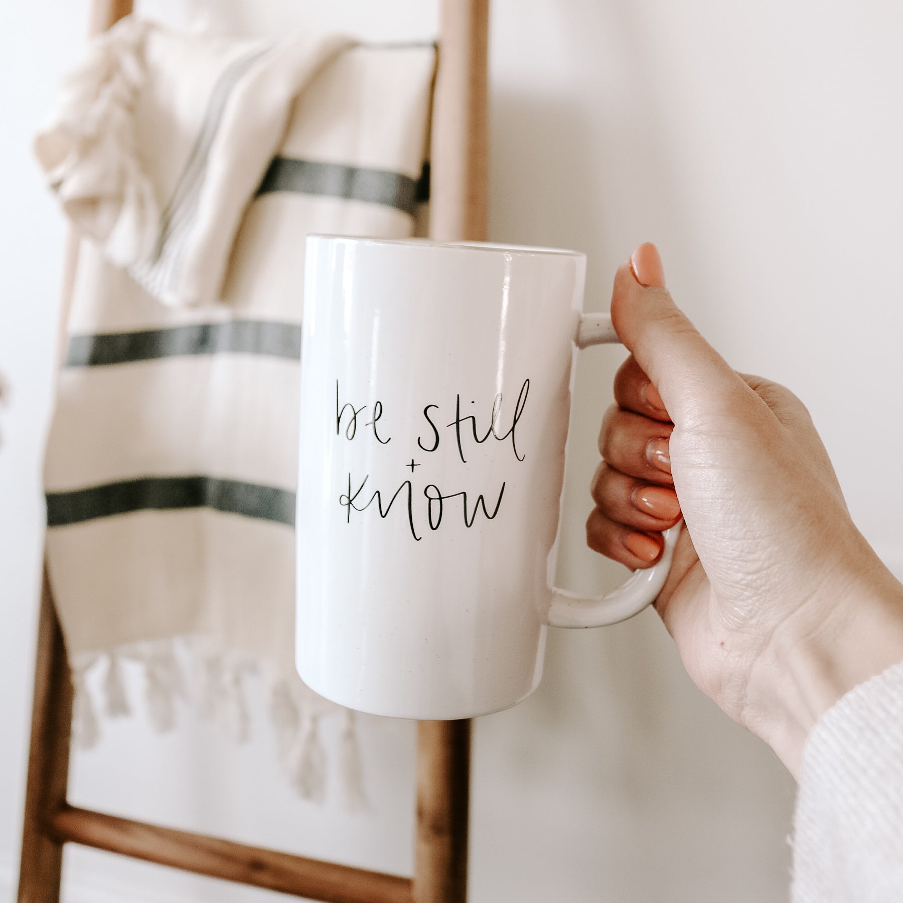https://www.sweetwaterdecor.com/cdn/shop/products/CM100-BE-STILL-AND-KNOW-TALL-CERAMIC-MUG-MARCH-2022-SWEET-WATER-DECOR-3_1800x1800.jpg?v=1674088331